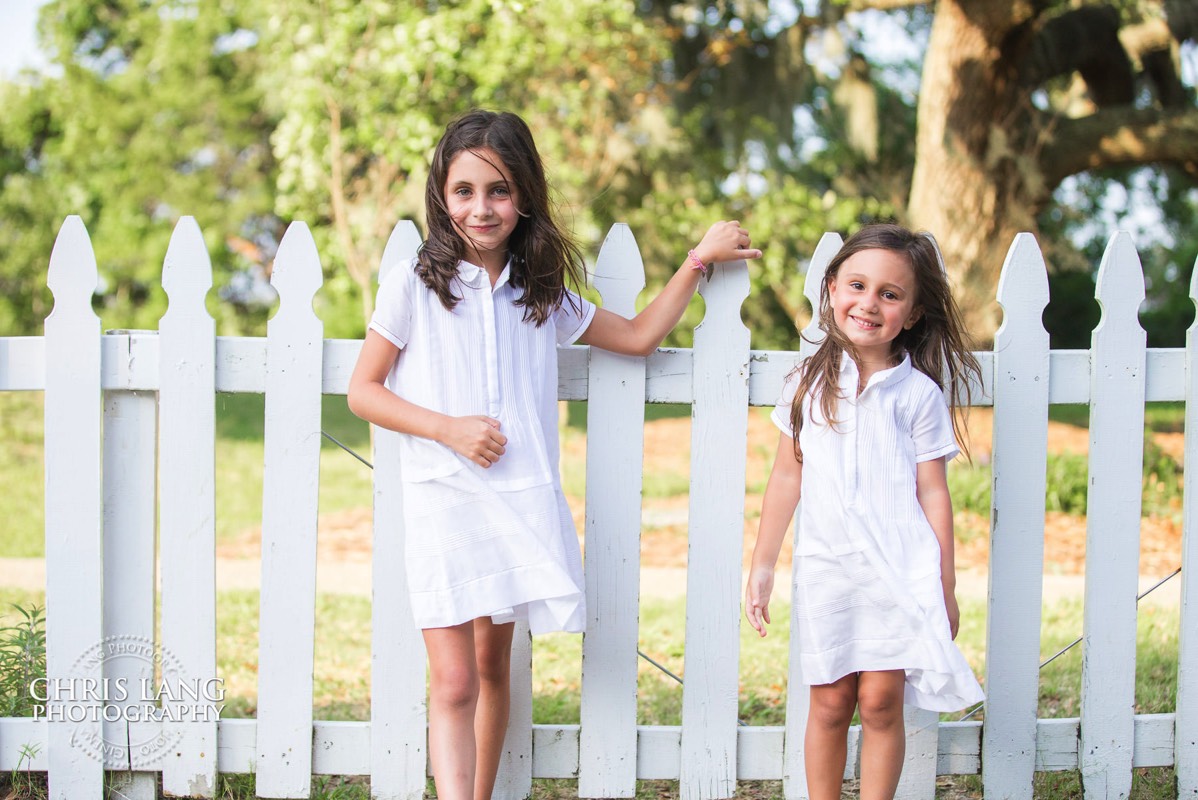 Two young gorls pose fro family photos on Bald Head Island - Places for family vacation - Bald Head Island Photographers - BHI Photography - Kids Portraits -  Pictures on Bald Head Island - BHI Photo Services - Chris Lang Photography 
