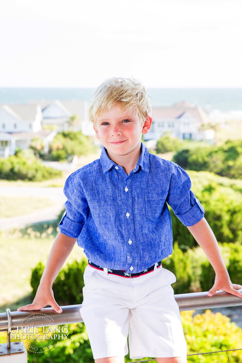 lifestyle photo of boy in blue shirt and kaki shorts - Places for family vacation - Bald Head Island Photographers - BHI Photography - Kids Portraits -  Pictures on Bald Head Island - BHI Photo Services - Chris Lang Photography 