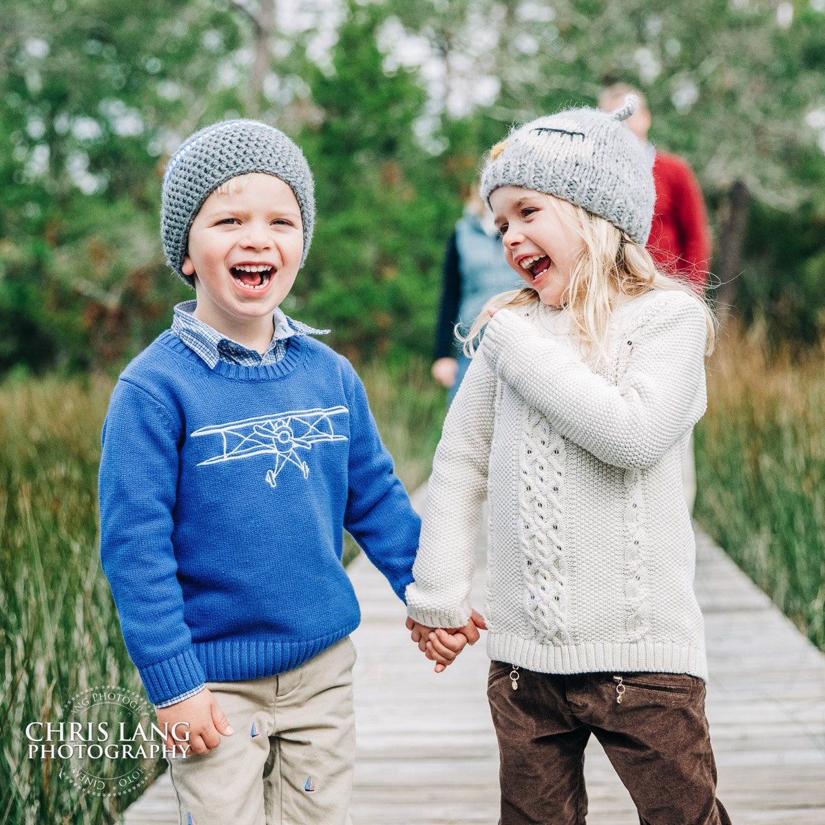 brother and sister holding hands and laughing - Places for family vacation - Bald Head Island Photographers - BHI Photography - Kids Portraits -  Pictures on Bald Head Island - BHI Photo Services - Chris Lang Photography 