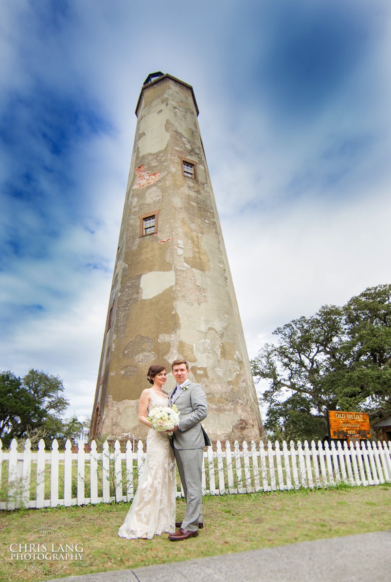 bride and groom in front of old baldy lighthouse - wedding flowers - Bald Head Island NC Weddings - Photographers - Bride - Groom - Wedding Dress - wedding photography - chris lang photography - destination wedding - Bald Head Island Wedding Venue 
