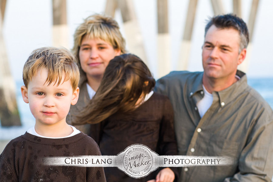 A family walking on the beach during family photography session in Wilmington NC