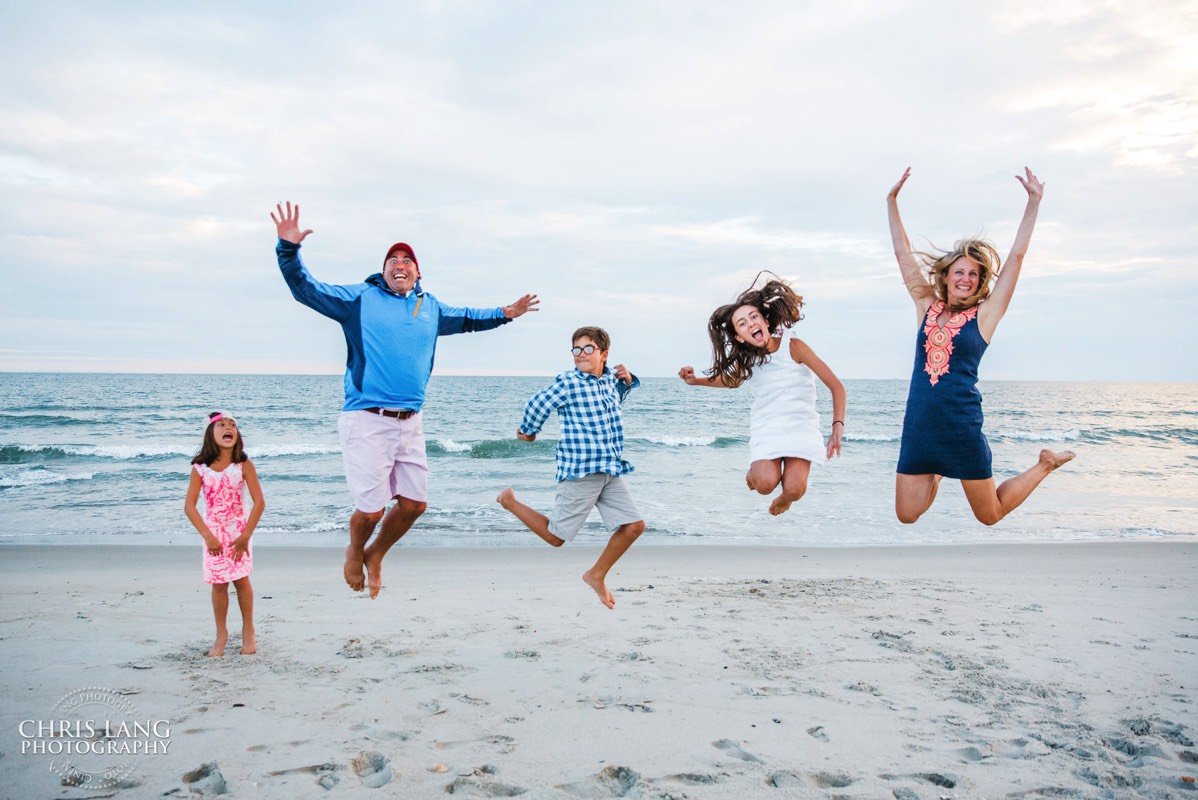 family having fun on the beach jumping in the air - fun photo - vacation fun - Bald Head Island Family Photo - BHI Photographers - Family Photo - Bald Head Island Photography - Chris Lang Photography  -  