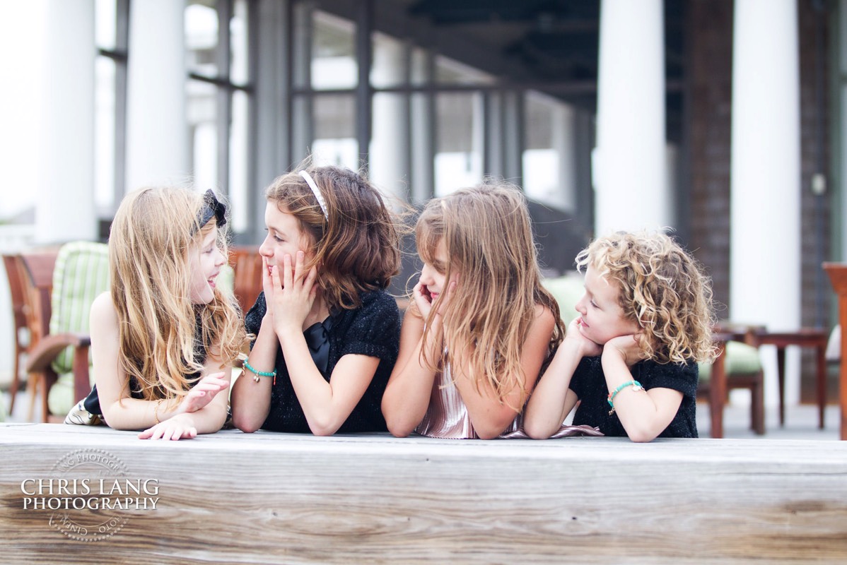 candid photo of littel girls in fron of the shoals club - Bald Head Island Photographers - BHI Photography - Kids Portraits -  Pictures on Bald Head Island - BHI Photo Services - Chris Lang Photography 