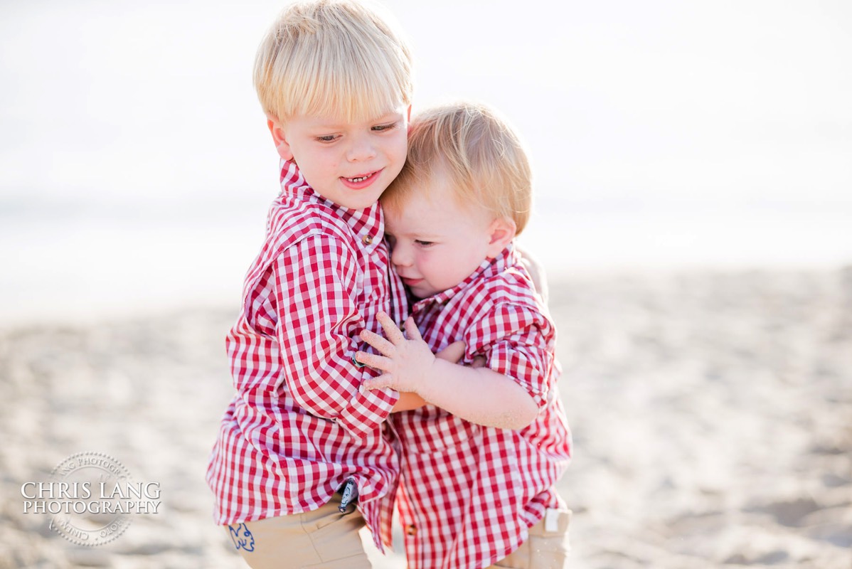 two boys plaing on the beach - shoals club - Bald Head Island Photographers - BHI Photography - Kids Portraits -  Pictures on Bald Head Island - BHI Photo Services - Chris Lang Photography 