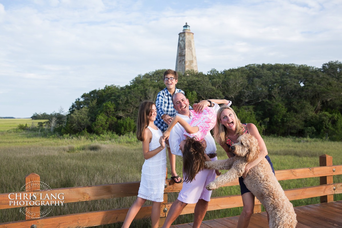 Bald Head Island Photographers - BHI Family Photography - Family Photos  - family portrait   family pictures  - BHI Photographer  - Bald Head Island pictures - Chris Lang Photography - candid photo of family posing for picture at Old Baldy  Lighthouse