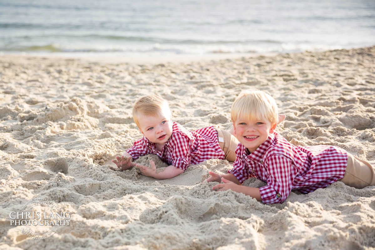 two little brithers playin in the sand at the beach - Bald Head Island Photographers - BHI Photography - Kids Portraits -  Pictures on Bald Head Island - BHI Photo Services - Chris Lang Photography 