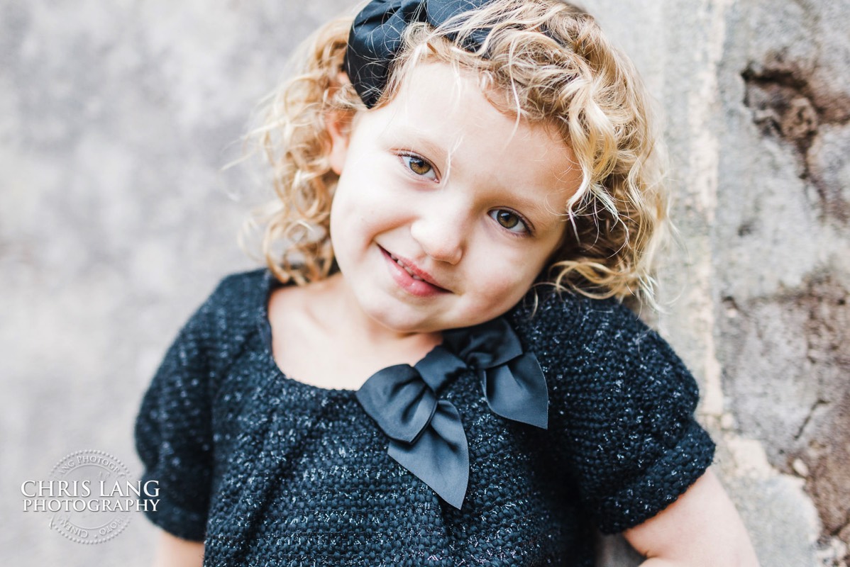 little girl in dress with bow in hair - Old Baldy - Bald Head Island Photographers - BHI Photography - Kids Portraits -  Pictures on Bald Head Island - BHI Photo Services - Chris Lang Photography 