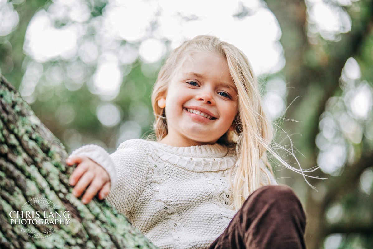 Bald Head Island Photographers - BHI Photography - Kids Portraits -  Pictures on Bald Head Island - BHI Photo Services - Chris Lang Photography - image of little girl playing in a tree
