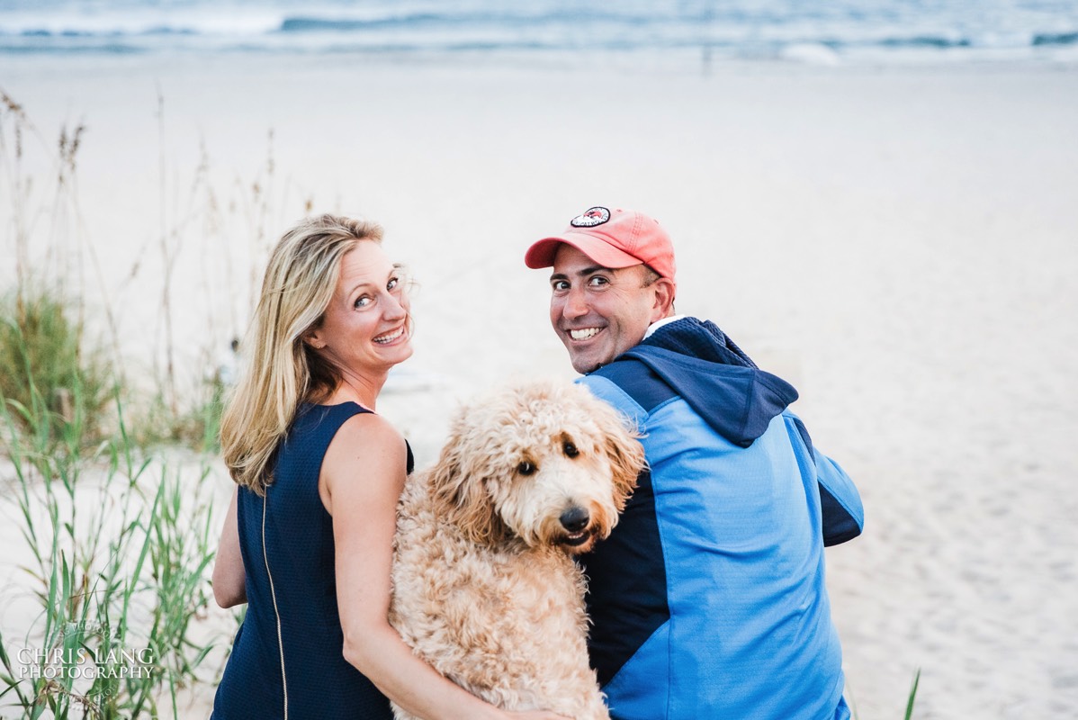coulple on beach with dog - having fun - familly portrait - ocean - Bald Head Island Family Photo - BHI Photographers - Family Photo - Bald Head Island Photography - Chris Lang Photography  - 