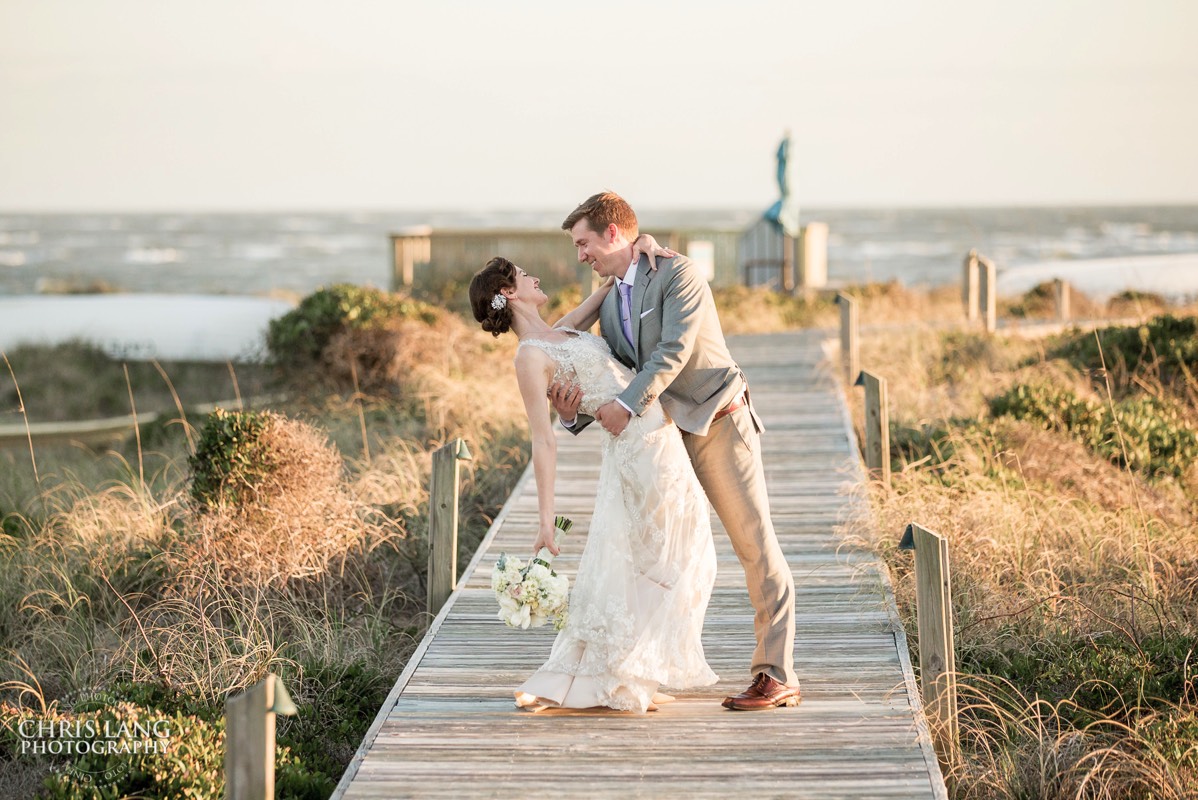 bride and groom with ocea in the background - Shoals Club -  wedding reception  -Bald Head Island NC Weddings - Photographers - Bride - Groom - Wedding Dress - wedding photography - chris lang photography - destination wedding - Bald Head Island Wedding Venue 