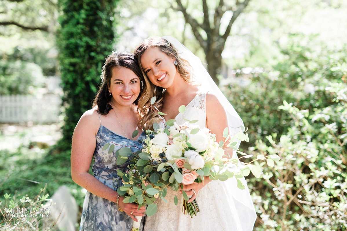 Bride and Matron of Honor picture in fron of the Village Chapel   - Bald Head Island NC Wedding Photography - BHI Wedding Photographers - Wedding Dress -  Chris Lang Photography - Destination Weddings -  Bald Head Island wedding picture - BHI Weddings