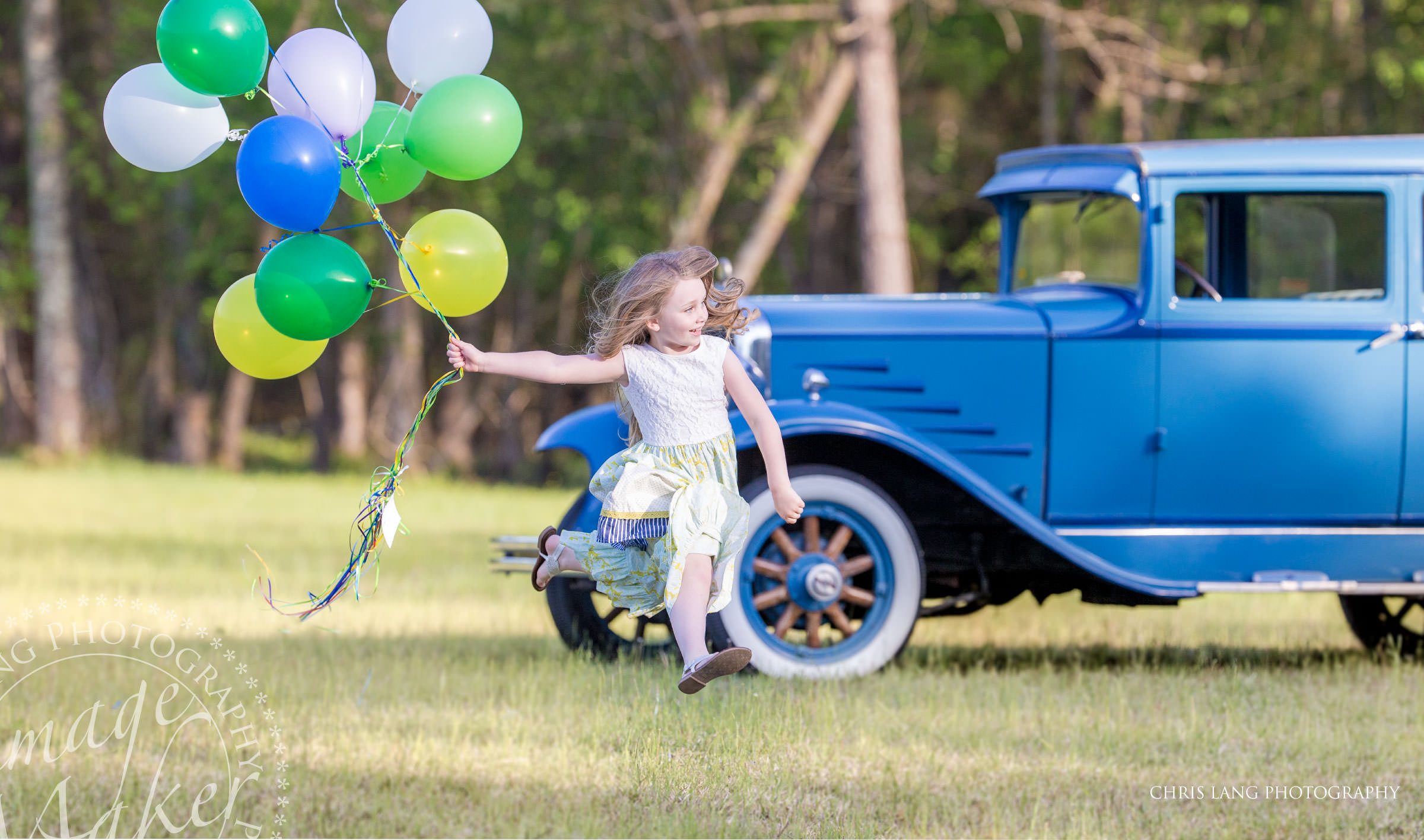 Wilmington NC Family Photographer - Family Photo - Lifestyle family photography - girl - sun dress - balloons - vintage car - little girl rungin & jumping in the air with ballons   - Family photo - family picture