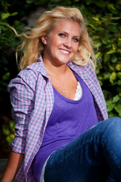 WIlmington NC Senior Porttait Photographers picture of Girl in purple shirt sitting on a park bench