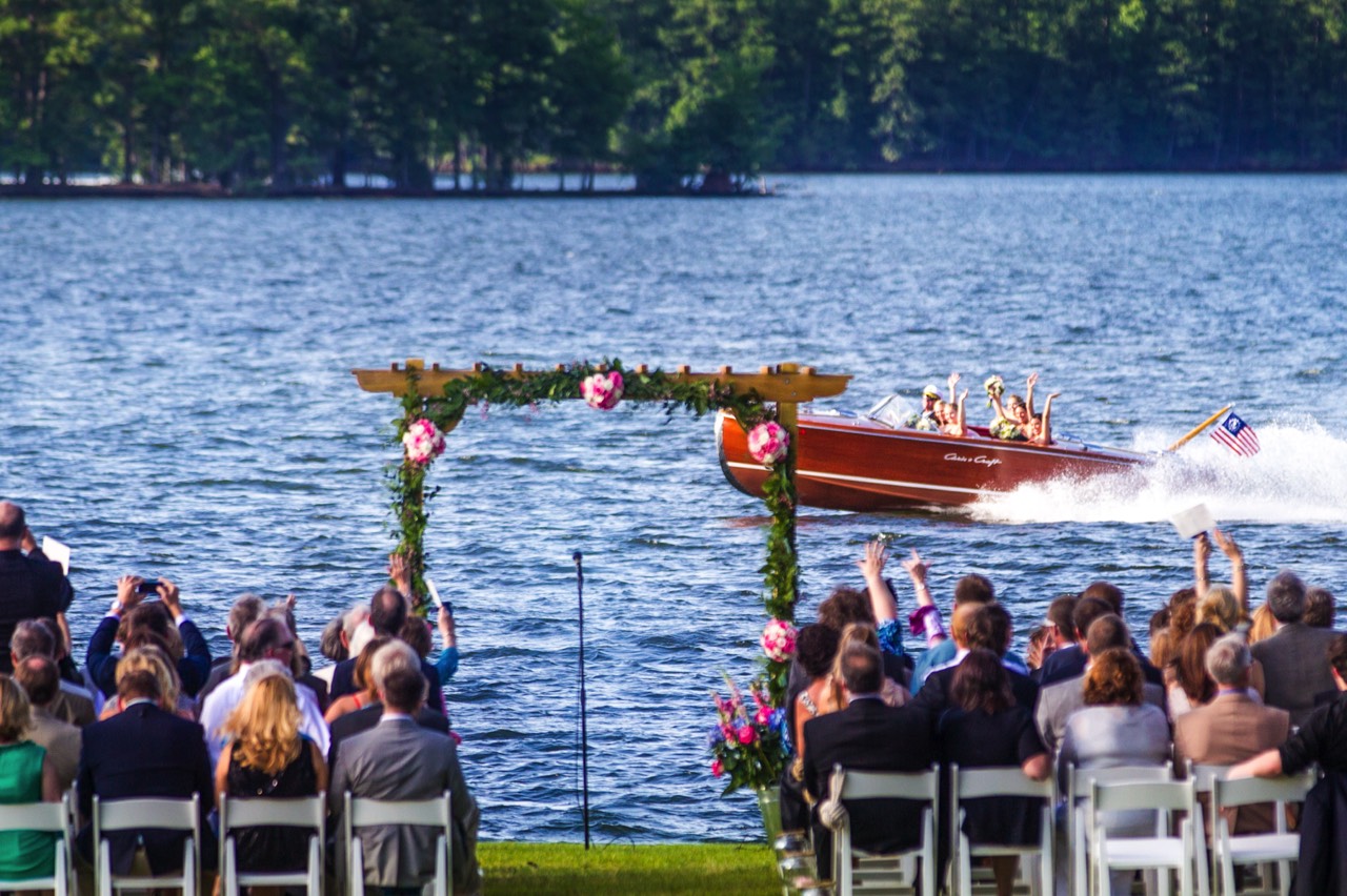 Picture of Bridesmaids entering wedding in a Chris Craft Boat