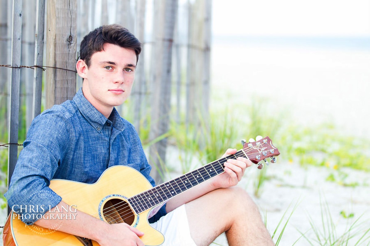 Image of highschooole senior boy on the beach with his guitar - Senior portrait ideas - Wrightsville Beach High School Senior Photography - Wrightsville Beach Photographers - Beach Senior Portrait  Photos- Chris Lang Photography  