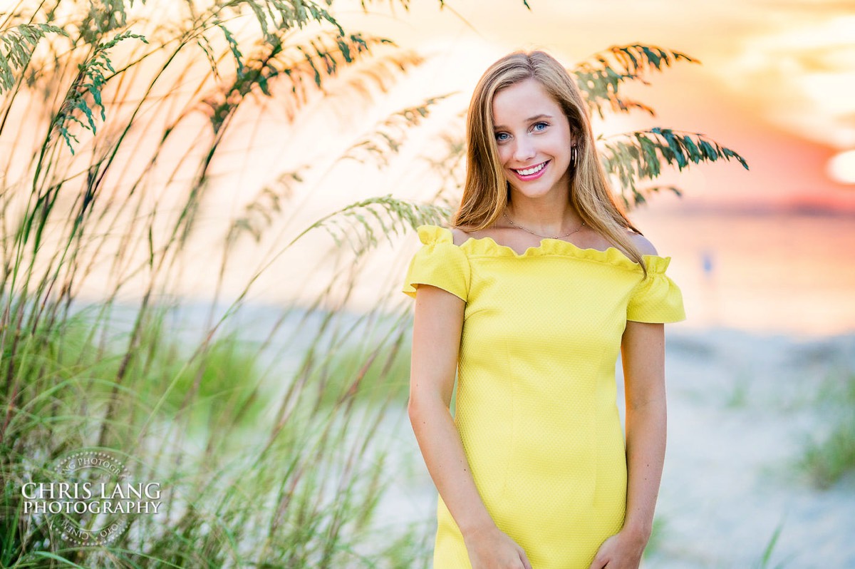 image of highschoole senior girl wearing a a yellow dress on the beach at sunset - golden hour beach photo - Wrightsville Beach High School Senior Photography - Wrightsville Beach Photographers - Beach Senior Portrait  Photos- Chris Lang Photography  