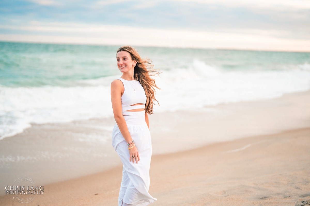 Highschool senior girl gettgin here senior portraits done on the beach - white dress - outfir ideas - Wrightsville Beach High School Senior Photography - Wrightsville Beach Photographers - Beach Senior Portrait  Photos- Chris Lang Photography  