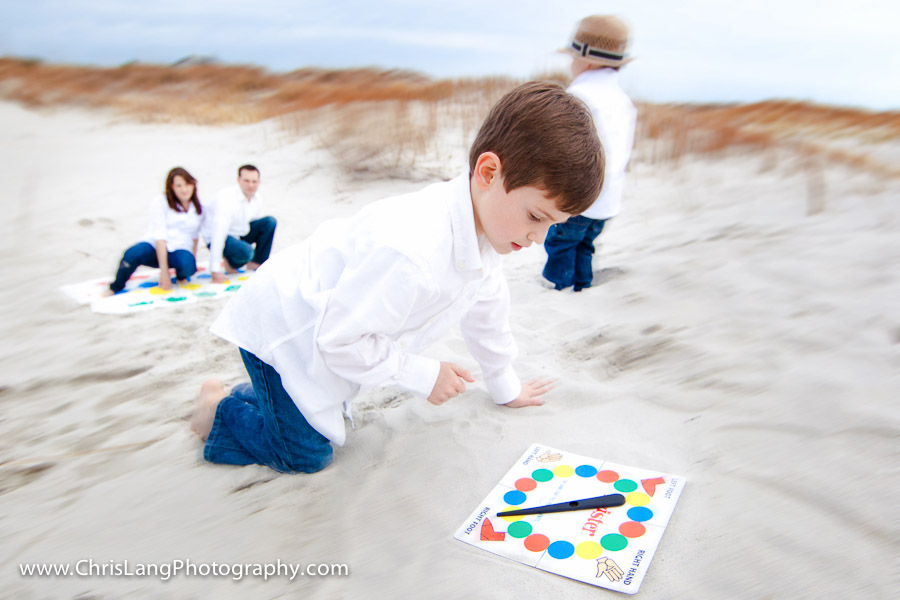 A young boy spinning a twister board at the beach during Lifestyle Photo Session