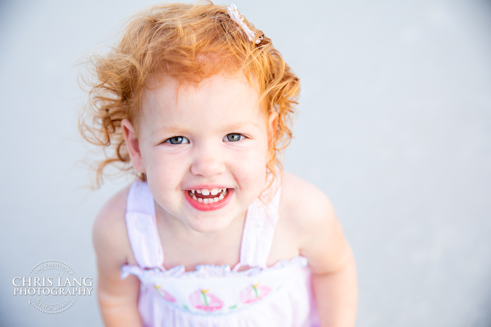 Image of a little girl smiling on the beach - Figure Eight Island Photography - Photographers - Figure 8 Island  - Photography Services - Chris Lang Photography - 