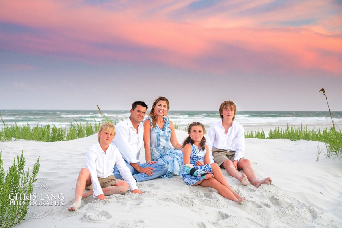 family portrait photography - wilmington nc family portrait photpgraphers - image of family on beach - sunset family picture -  chris lang photography