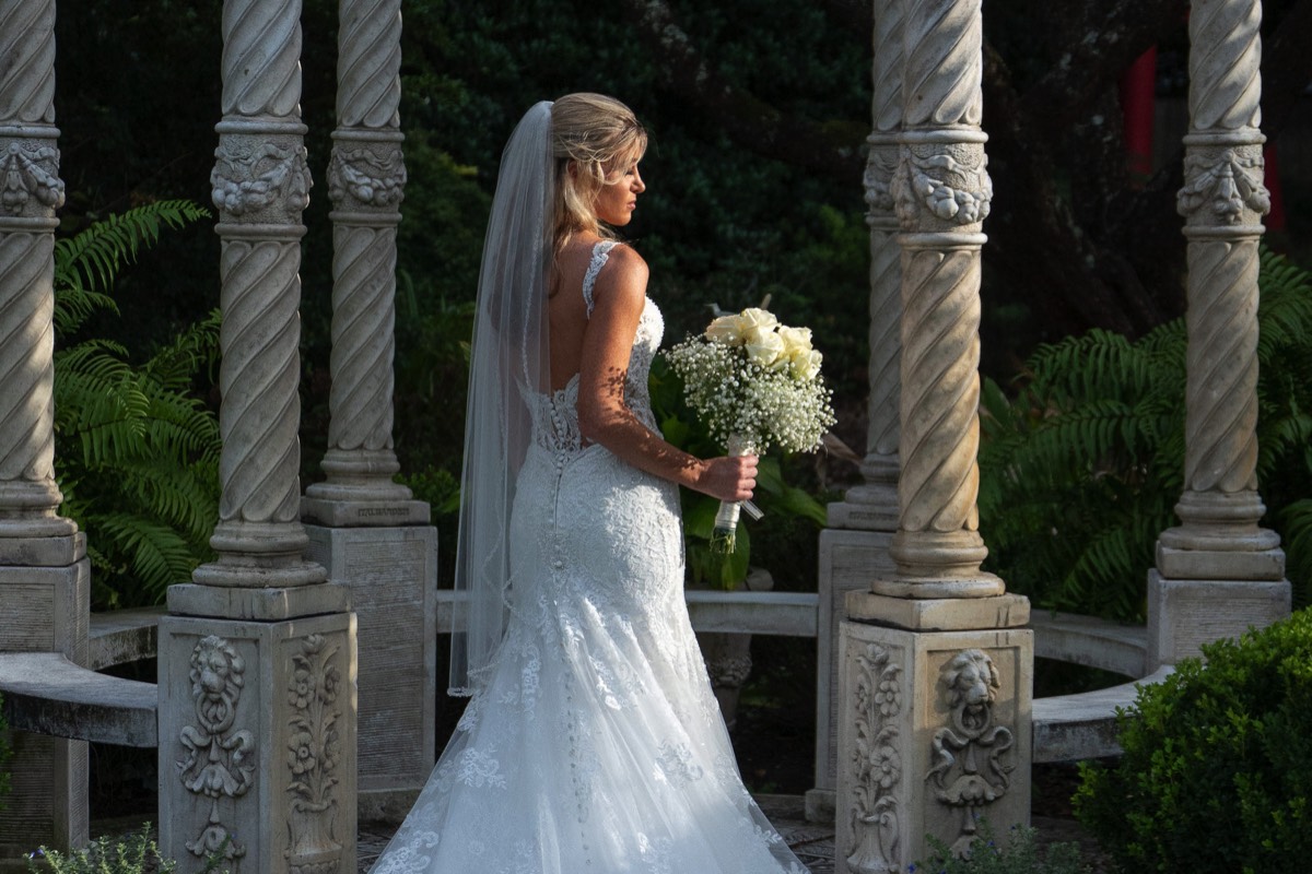 Image of Bride in her wedding dress - wedding boquet -  Garden Bridal portrait -  wedding dress ideas - arboretum - wilmington nc wedding photographer - natural light wedding photo - chris lang photography