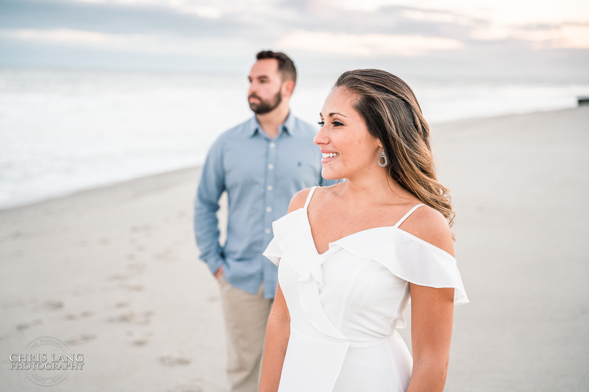 Bright and Airy Engagement photo - Couple wrapped  in Christmas lights on the beach - Fort Fisher North Carolina -  Engagement Photography - Wedding Ideas - Popular engagement photography locations - Lifestyle engagement photo -  Ft Fisher engagement photographers - Engagement session ideas - New trends in engagement photography - Chris Lang Photography - Engagement photos 