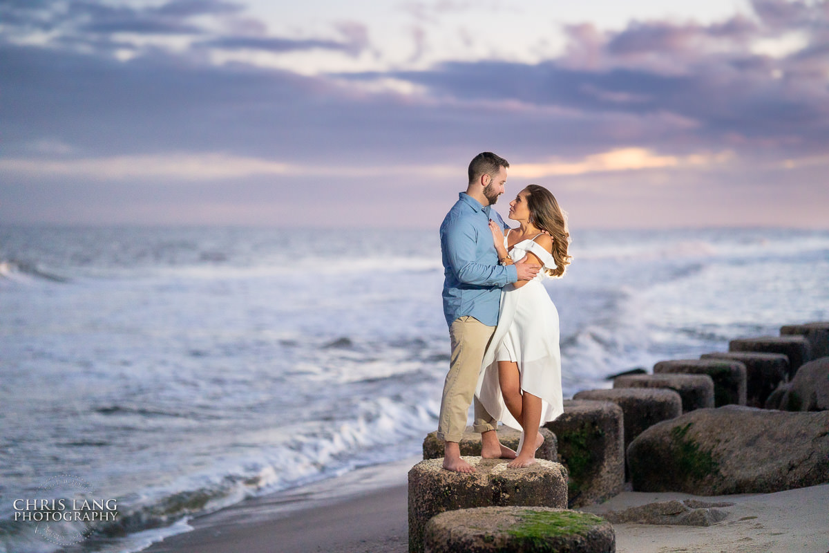 Couple Photo on the beach at sunset - Fort Fisher North Carolina -  Engagement Photography - Popular engagement photography locations - Lifestyle engagement photography -  Ft Fisher engagement photographers - Engagement session ideas - Trends in engagement photography - Chris Lang Photography - Engagement photos 
