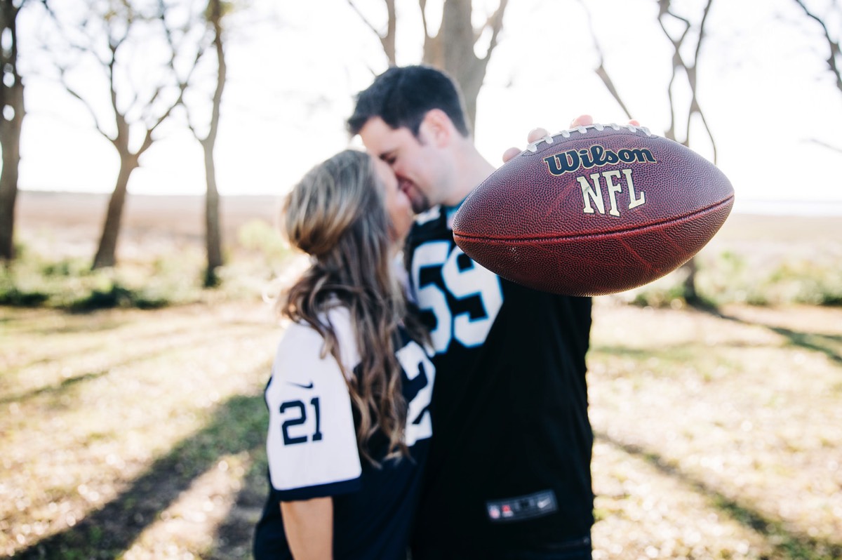fun engagement photo - football jerseys - Fort Fisher North Carolina -  Engagement Photography - Popular engagement photography locations - Lifestyle engagement photography -  Ft Fisher engagement photographers - Engagement session ideas - Trends in engagement photography - Chris Lang Photography - Engagement photos 