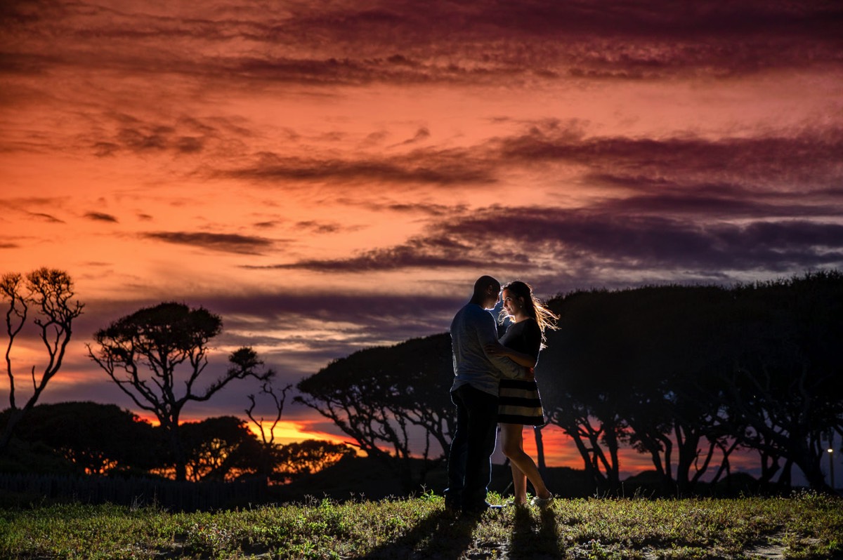 Epic twilight photo of couple  - Fort Fisher North Carolina -  Engagement Photography - Wedding Ideas - Popular engagement photography locations - Lifestyle engagement photo -  Ft Fisher engagement photographers - Engagement session ideas - New trends in engagement photography - Chris Lang Photography