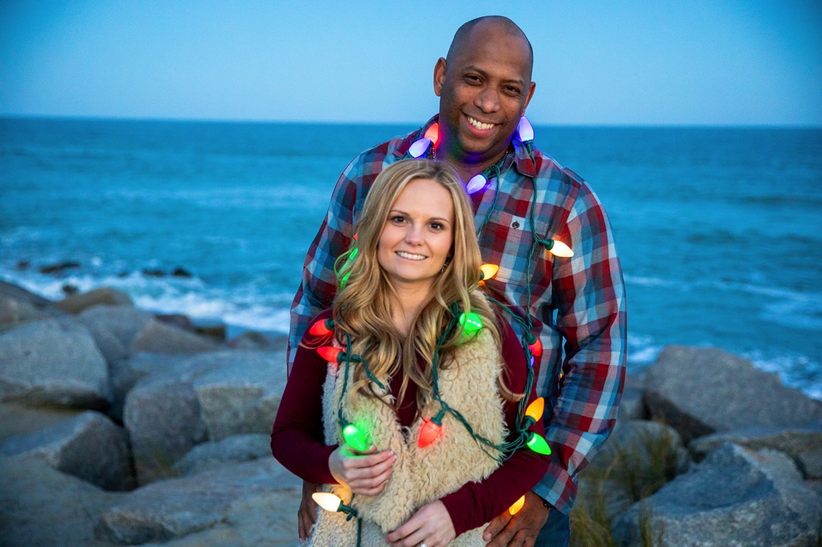 Couple wrapped  in Christmas lights on the beach - Fort Fisher North Carolina -  Engagement Photography - Wedding Ideas - Popular engagement photography locations - Lifestyle engagement photo -  Ft Fisher engagement photographers - Engagement session ideas - New trends in engagement photography - Chris Lang Photography - Engagement photos  