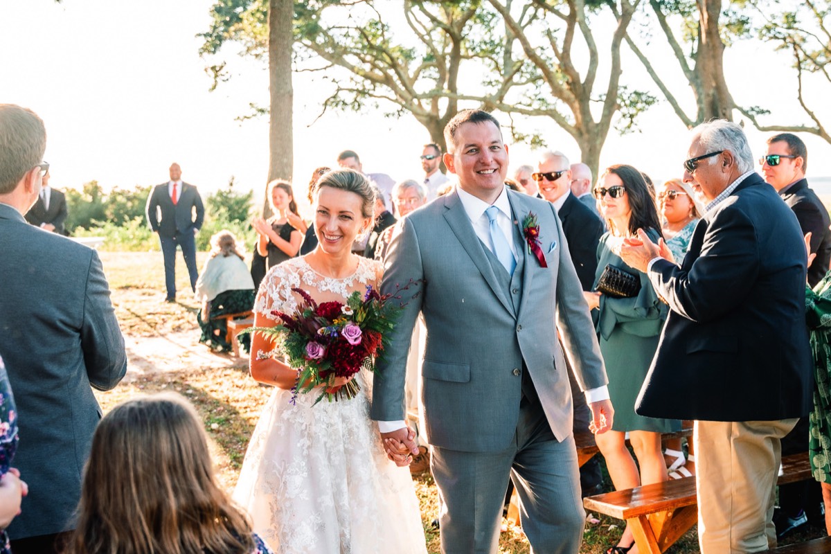 Bride & groom walking down the isle  - outdoor weddings -   Fort Fisher North Carolina -  Wedding Photography - Wedding Ideas - Bride - Groom - Wedding Dress - Chris Lang Photography- Popular wedding location - 