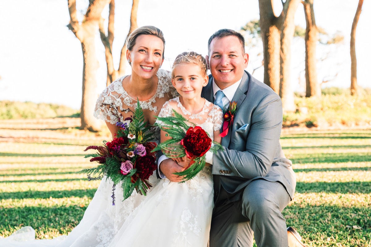 Flower girl with bride and groom  -  outdoor weddings -   Fort Fisher North Carolina -  Wedding Photography - Wedding Ideas - Bride - Groom - Wedding Dress - Chris Lang Photography- Popular wedding location - 