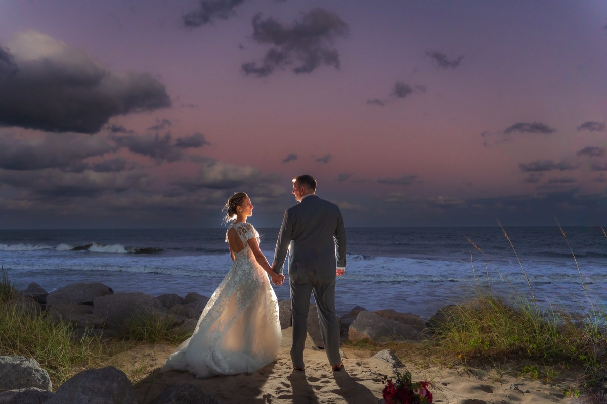 Bride & groom on the beach  - beach wedding photo -   Fort Fisher North Carolina -  Wedding Photography - Wedding Ideas - Bride - Groom - Wedding Dress - Chris Lang Photography- Popular wedding location -  