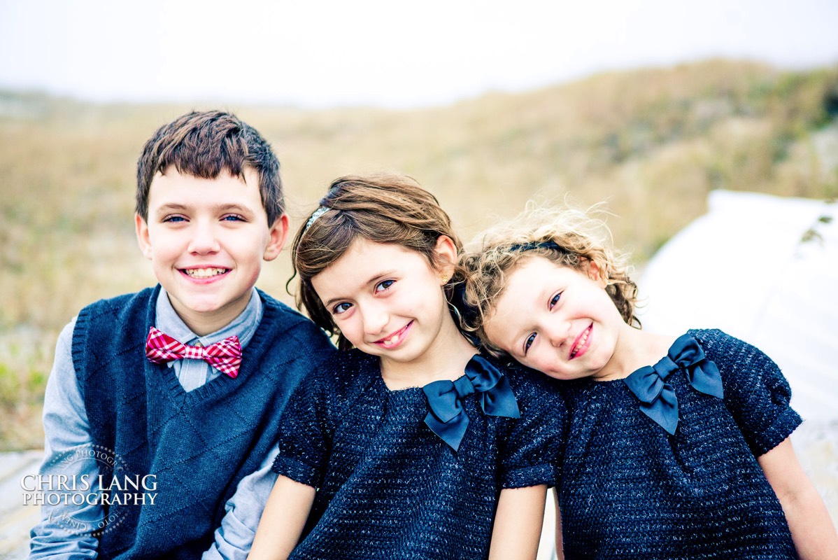 Places for family vacation - Bald Head Island NC Photographers - BHI Photography - Kids Portraits -  Pictures on Bald Head Island - BHI Photo Services - Chris Lang Photography  - Image of young brother and sisters  smiling for picture