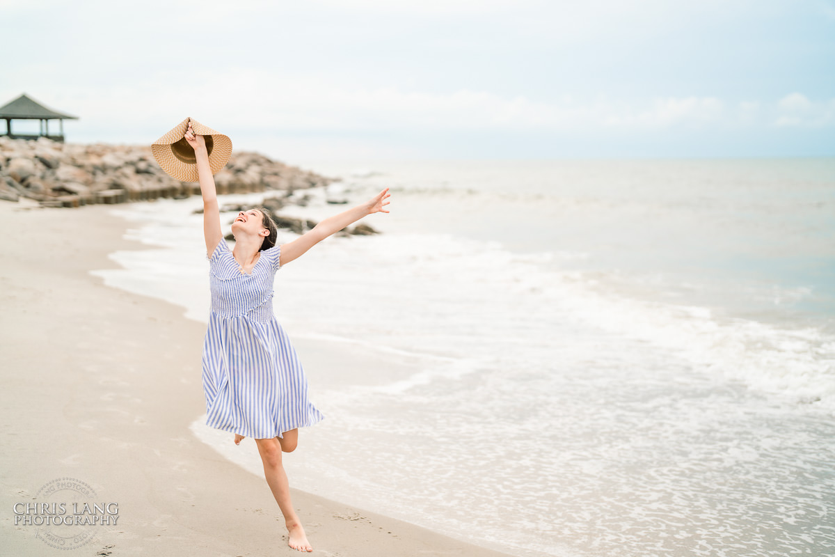 Younf girl running on the beach at Fort Fisher- Family Photo Session- Fort Fisher Photography - Photos in Fort Fisher - Family Portraits -