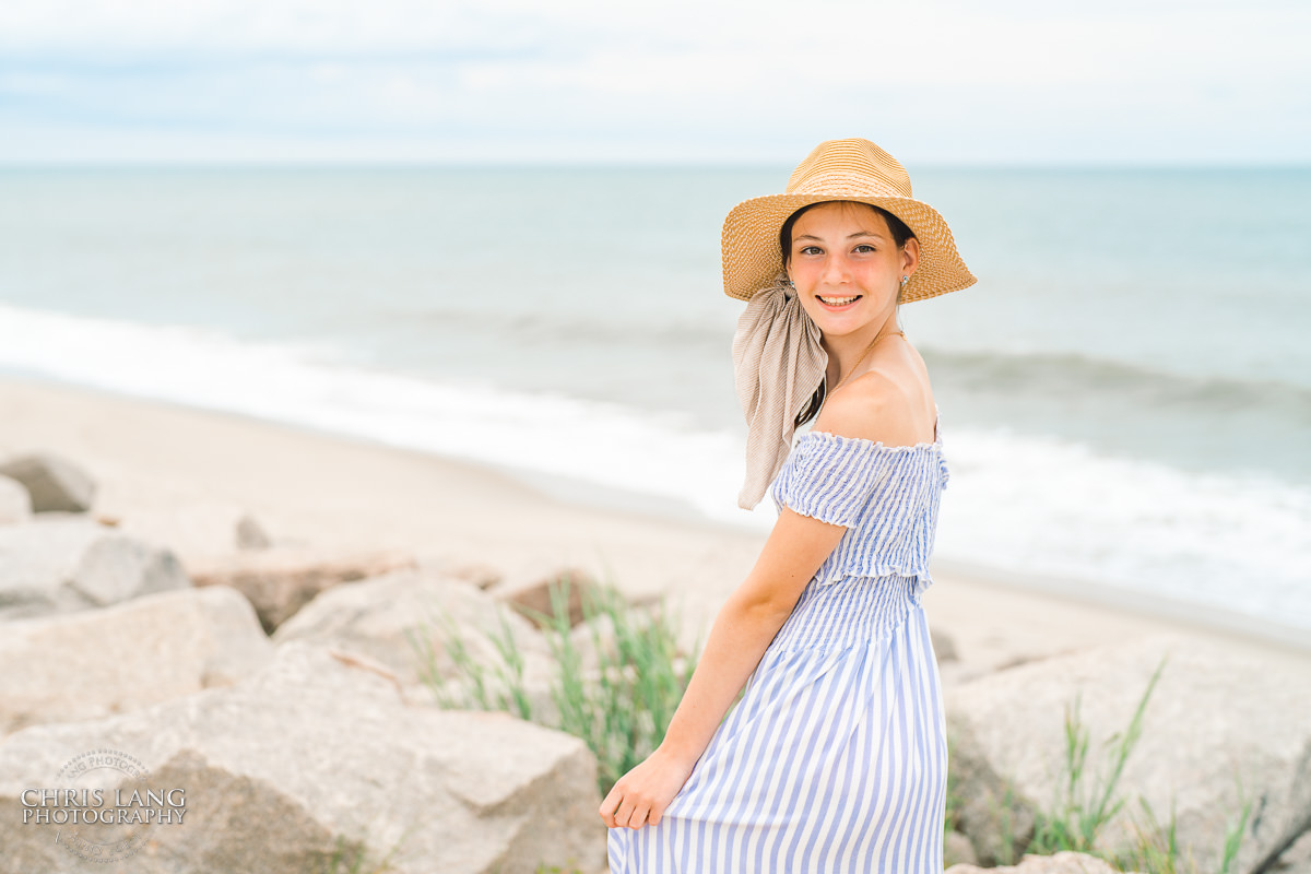 young girl posing on the beach - sun hat - Fort Fisher- Family Photo Session- Fort Fisher Photography - Photos in Fort Fisher - Family Portraits -