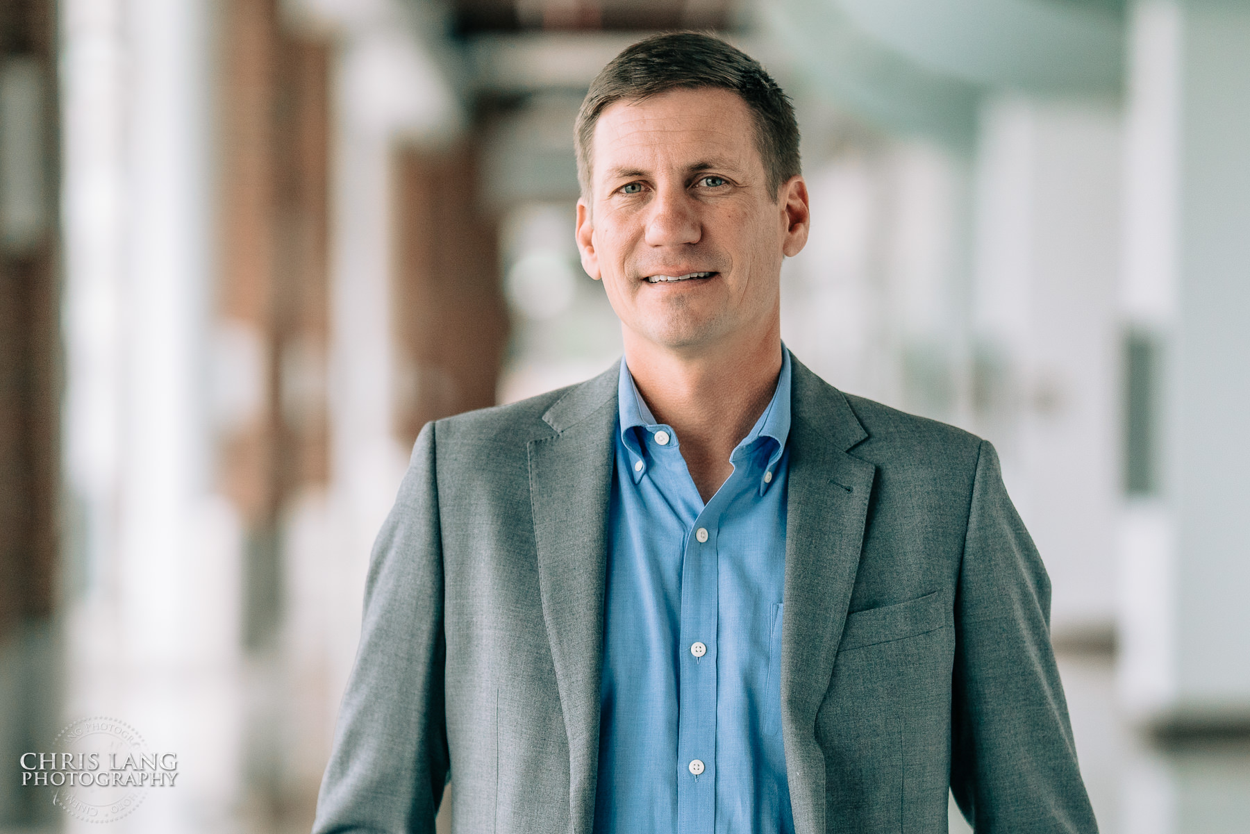 Branding headshot - Male wearing gray blazer - Wilmingotn Convention Center - Wilmington NC Headshot Photography - Lifestyle Headshot - Branding Headshots  -Chris Lang Photography -  