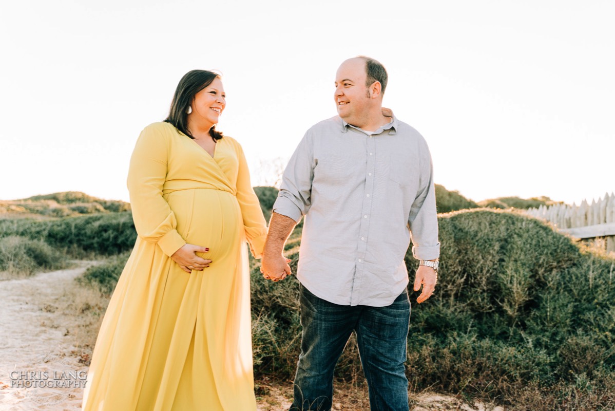 maternity picture - couple walking in Ft Fisher - maternity - wilmington nc maternity photographers - chris lang photography -  pregnancy photos -  maternity photo ideas