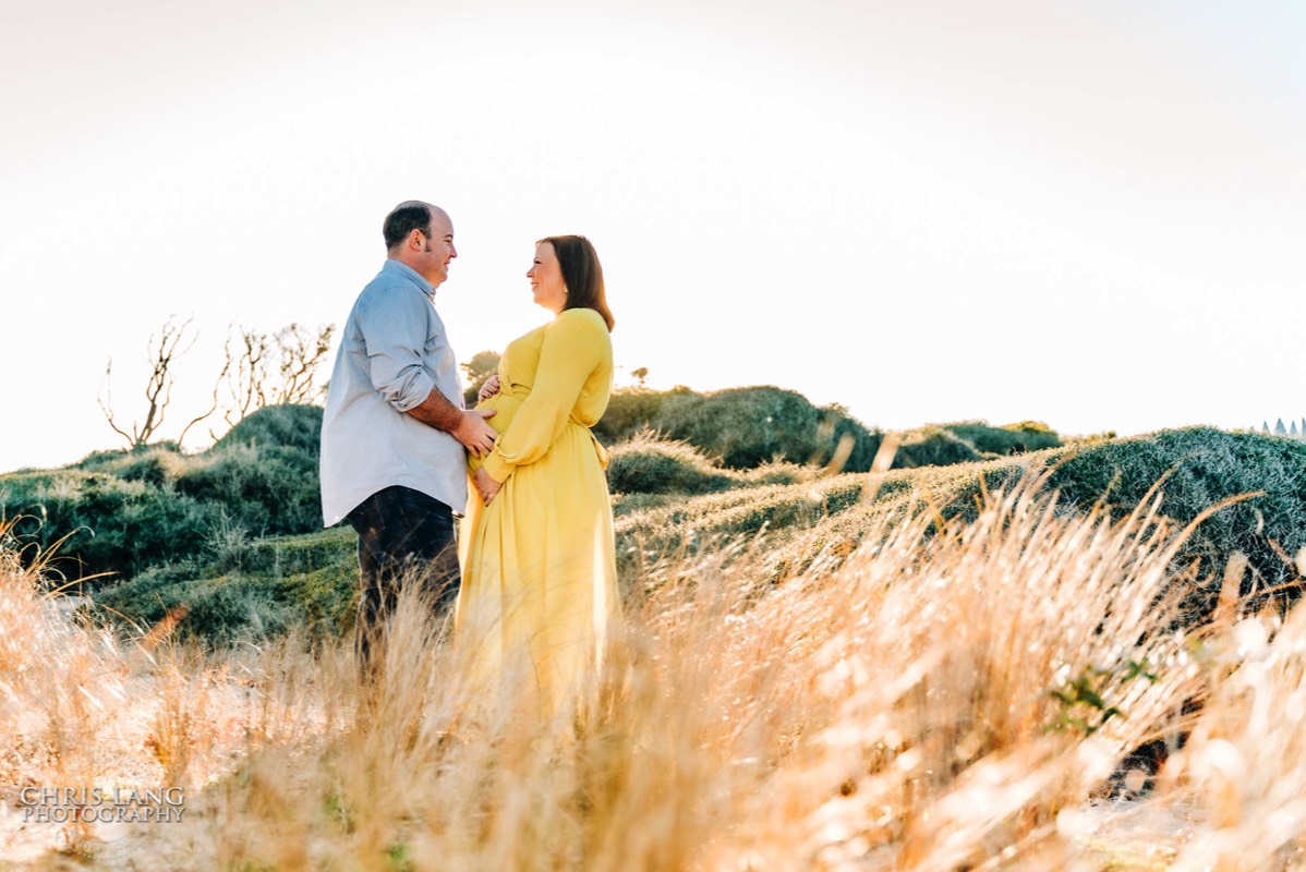 Couple in the fileds of Ft Fisher - baby bump photo -  maternity - wilmington nc maternity photographers - chris lang photography -  pregnancy photos -  maternity photo ideas