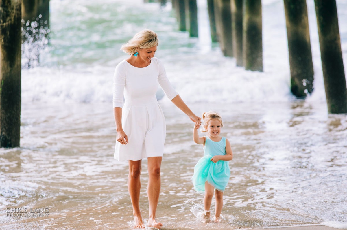 Mom walking with little girl int the waves - Surf City -  -Topsail Island Photography - Topsail Island NC Photographers - Chris Lang Photography -  Beach Photography - Family Photographer - Family photo - Beach Photographer - Beach Portraits -  Coastal Lifestyle Photography