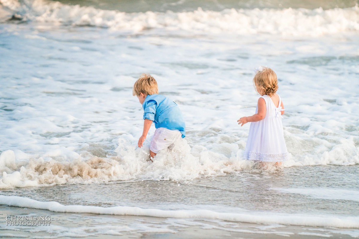  young kids pplaing in the water at the beach -Topsail Island Photography - Topsail Island NC Photographers - Chris Lang Photography -  Beach Photography - Family Photographer - Family photo - Beach Photographer - Beach Portraits -  Coastal Lifestyle Photography